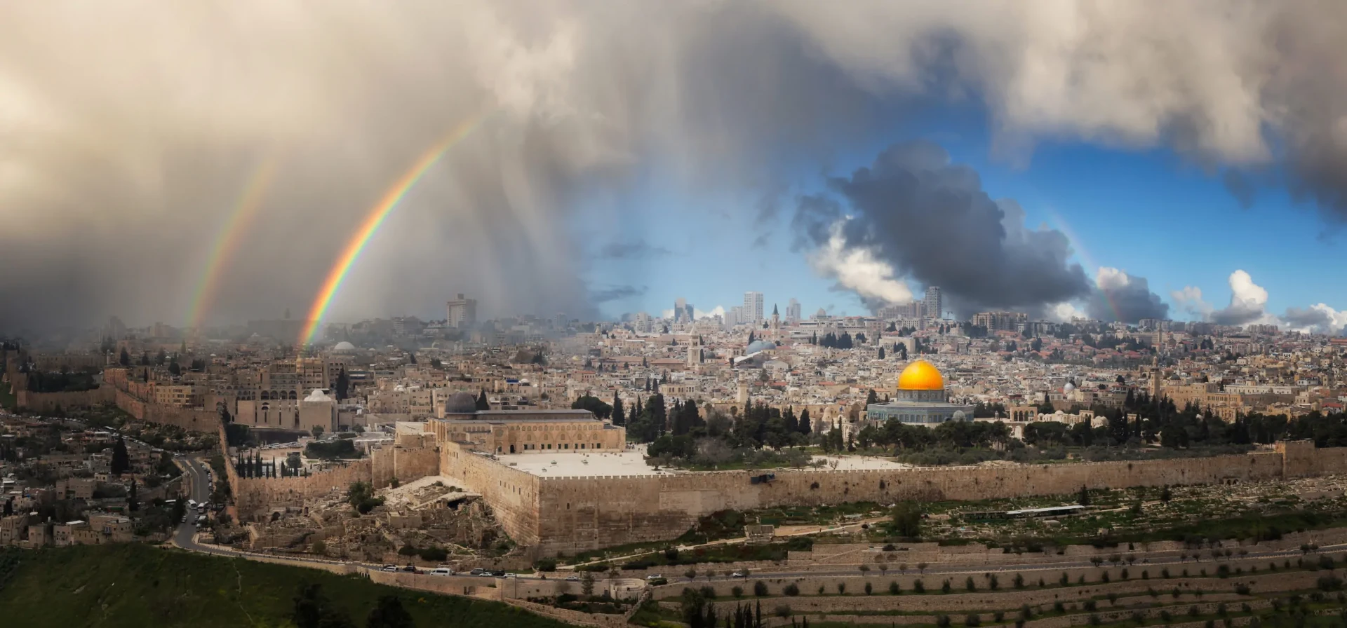 A real press photograph of Jerusalem's Old City and the Dome of the Rock beneath a double rainbow